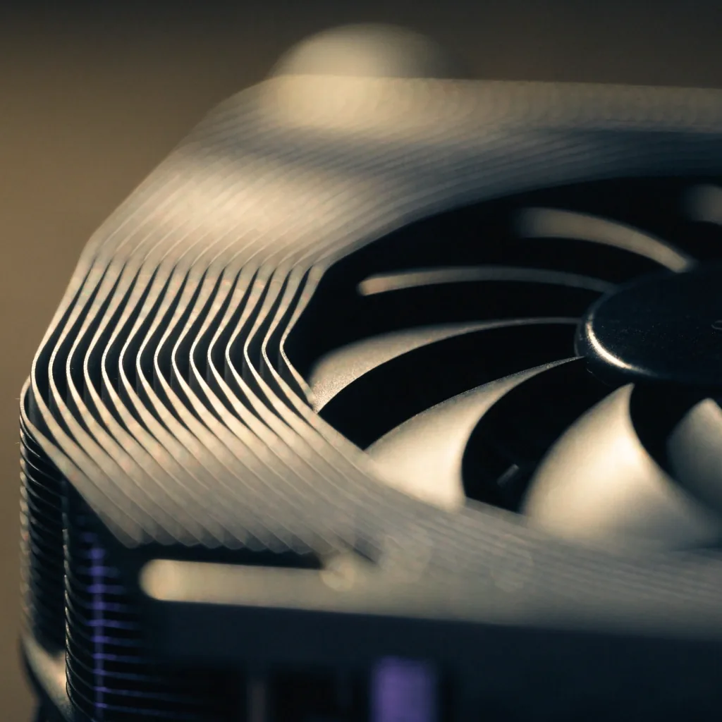 Close view of graphics card cooler fins under lamp light